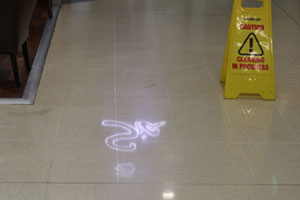 Terrazzo tiled floor showing reflection of shop logo after being diamond polished