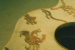 Positioning brass sea creature shapes in empty bar top