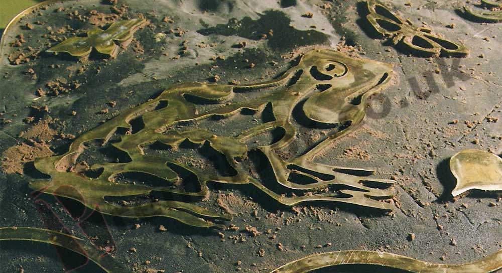 Frog cut from brass placed on epoxy screed in bar top